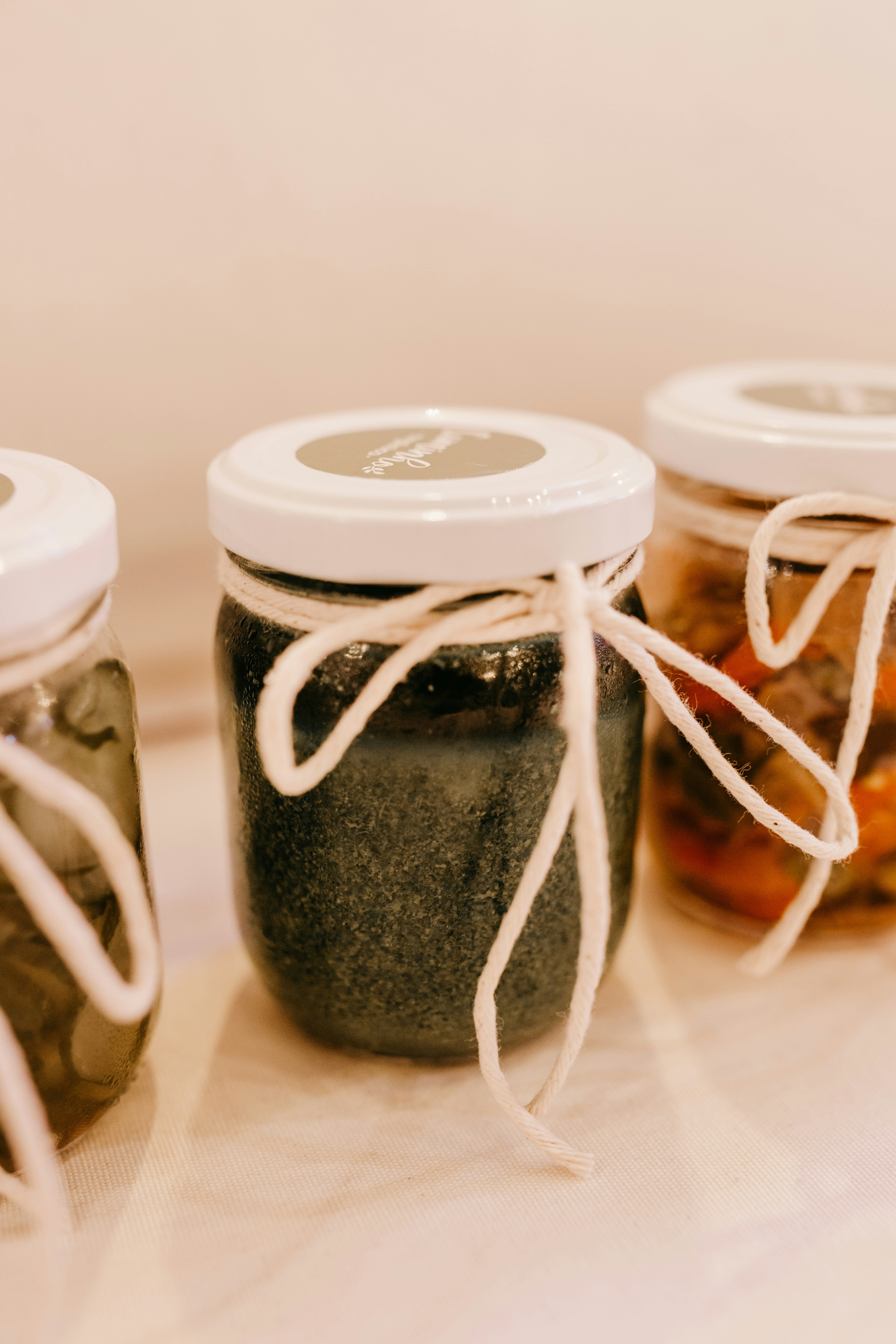 2 white and black ceramic jars